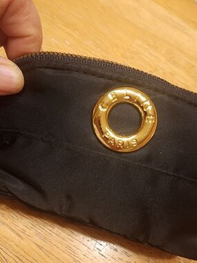 black nylon Celine cosmetic pouch featuring a gold-toned logo ring